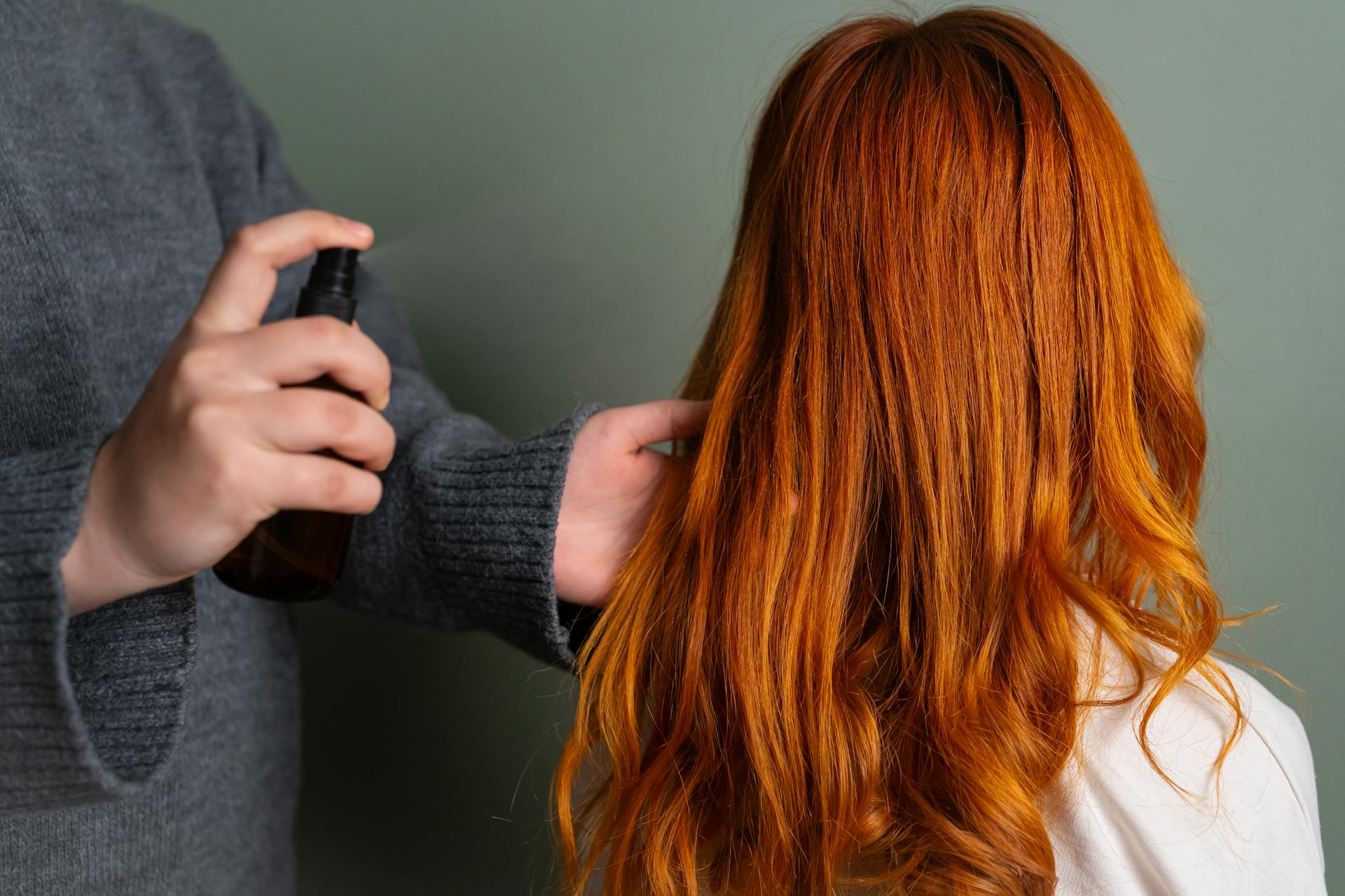 red haired model getting hair spray