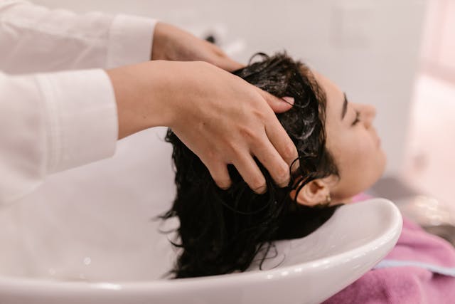 woman in salon getting hair washed