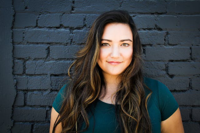 woman in front of blue wall