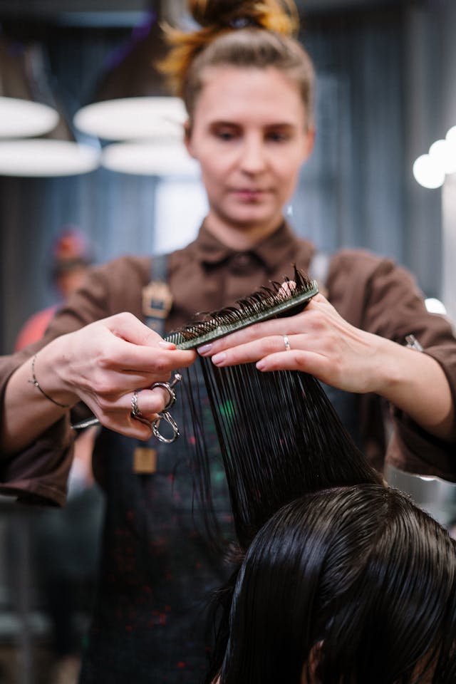 woman getting haircut in salon chair